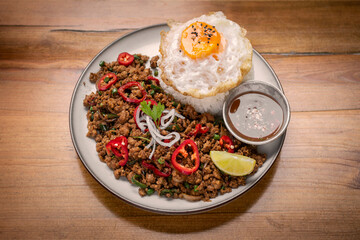 Pad Kra Pao Pork and Holy Basil Stir fry traditional thai food meal on table at restaurant in phuket thailand