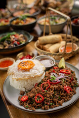 Pad Kra Pao Pork and Holy Basil Stir fry traditional thai food meal on table at restaurant in phuket thailand