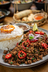 Pad Kra Pao Pork and Holy Basil Stir fry traditional thai food meal on table at restaurant in phuket thailand