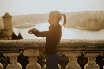 Sunrise stretching by the waterfront with a stunning cityscape backdrop