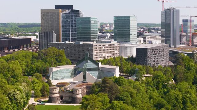 historical site green cover parked truck tall buildings glass windows business district background luxembourg city view urban landscape cityscape development 