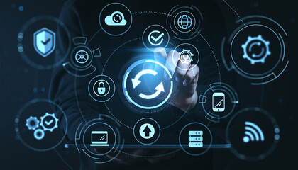 Digital transformation concept with hand interacting with sync icon among technology symbols on modern digital interface background.