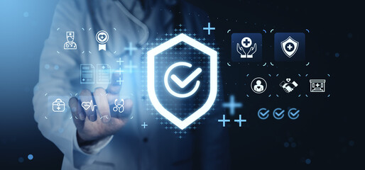 Doctor interacting with futuristic holographic interface displaying health insurance and medical service icons on dark digital background concept..