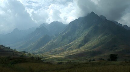 Fototapeta premium Expansive Terraced Rice Fields Nestled Amongst Majestic Mountain Ranges Under A Cloudy Sky