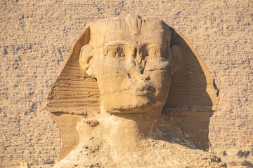 Exploration of the Sphinx at Giza during bright daylight hours by tourists interested in ancient history