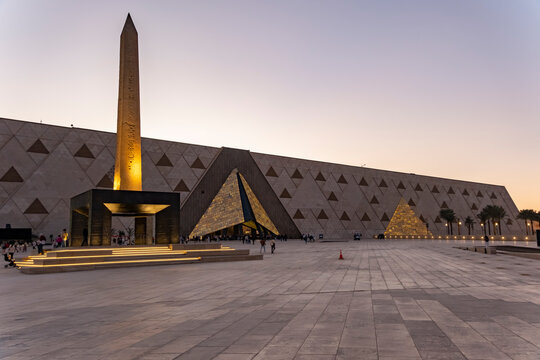 Grand Egyptian Museum near the pyramids and the obelisk at Giza in Egypt during the evening. Giza, Egypt - December 17, 2025