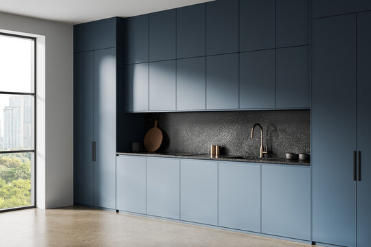 Sleek modern kitchen interior with matte blue cabinetry and minimalist design aesthetic featuring a terrazzo backsplash and brass faucet accent. 3D Rendering