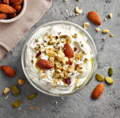 Greek yogurt topped with nuts and seeds, high protein breakfast concept, food photography