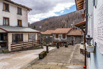 Picturesque street with traditional residential houses in the quiet mountain village of Pian degli Ontani, province of Pistoia, Tuscany region, Italy
