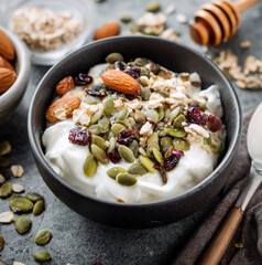 Greek yogurt topped with nuts and seeds, high protein breakfast concept, food photography
