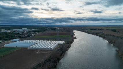 Aerial View of Greenhouses Along River Showing Agricultural Irrigation System