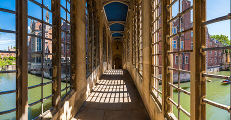 Cambridge, Great Britain  - July 12, 2025:  Historic Bridge of Sighs corridor at Cambridge University, overlooking the River Cam, an iconic view blending tradition, architecture, and serenity.