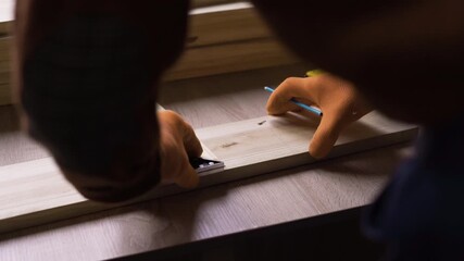 Carpenter elderly man working in carpentry workshop, measuring wooden board using measure tape triangle