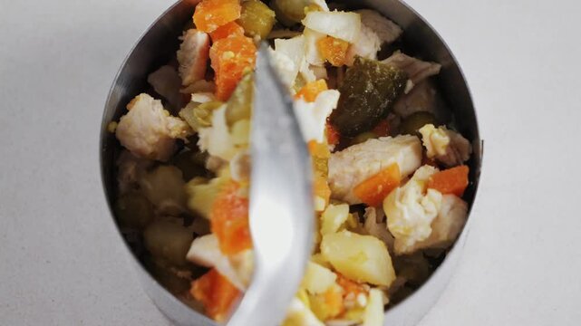 Salad preparation close up, laying out ingredients in a special salad mold. High quality 4k footage