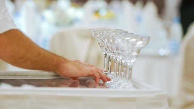 Waiter arranging champagne glasses for a celebration