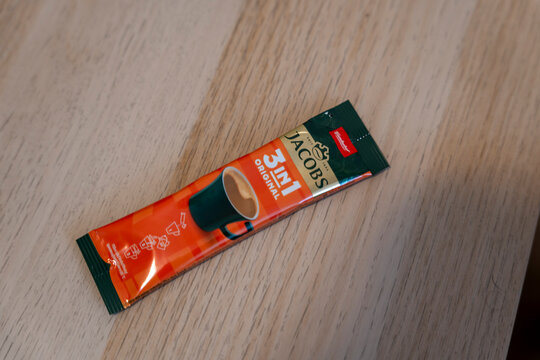 Rzeszow, Poland - Jan 6, 2026: A pack of Jacobs 3-in-1 coffee mix placed on a wooden surface. The product features vibrant packaging and offers easy preparation for instant coffee.