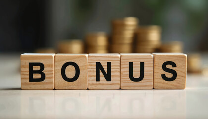 Wooden blocks spell bonus. Blurred gold coins stack background. Financial incentive concept. Idea for business success. Corporate reward theme. Employee benefits illustration. Marketing campaign for