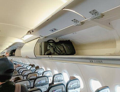 Carry on baggage on the overhead bin of the aircraft cabin