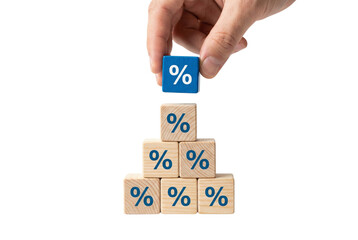 Hand Placing Blue Percentage Symbol Block on Top of Wooden Block Pyramid on Transparent Background