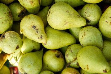 Close-up view of fresh green pears arranged together. Juicy and ripe fruit with natural texture and vibrant green color, symbolizing freshness, healthy nutrition and organic food. Ideal as food backgr