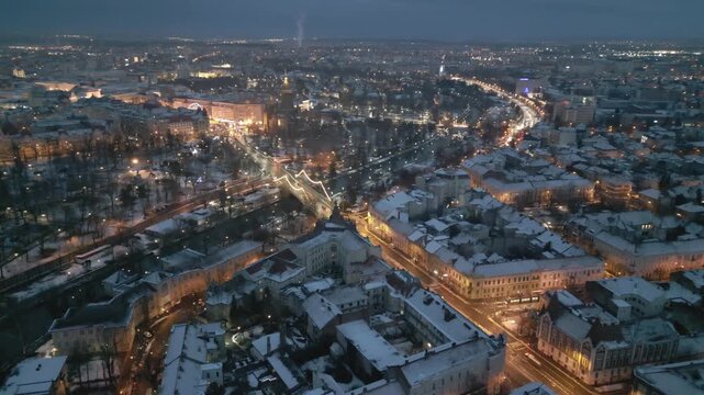Drone footage of the Orthodox Cathedral and Bega River in Timisoara, Romania, captured on January 3, 2026, during winter dusk with illuminated streets and snowy historic architecture.