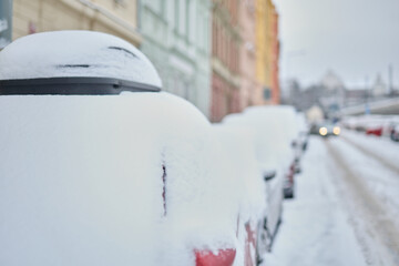 Snow calamity in city and removing snow from parked car