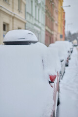 Snow calamity in city and removing snow from parked car