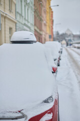 Snow calamity in city and removing snow from parked car