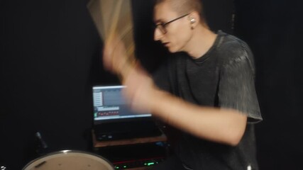 Informal drum and recording session with lively mood and warm ambiance