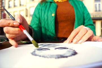 a girl draws in an album