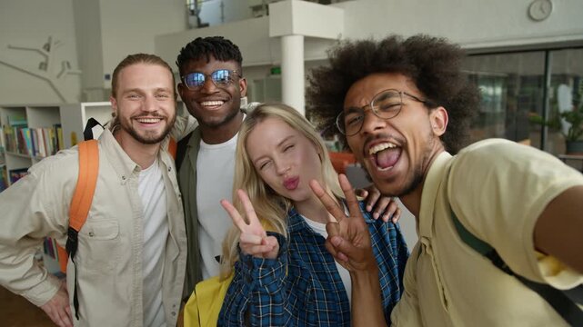 Webcam view four diversity students smiling cheerful posing for selfie photo social media vlog multiracial people smile carefree friends taking picture with mobile phone web cam in university college