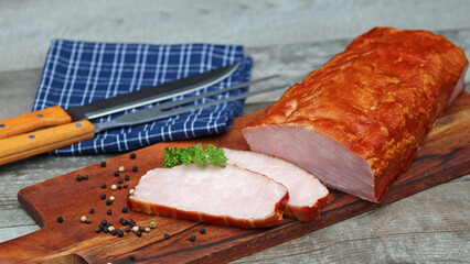 Smoked pork loin on a wooden board.