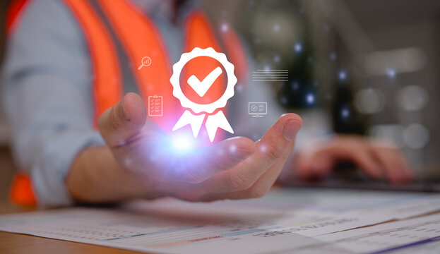 Engineer wearing safety vest holding glowing approval badge with checkmark icon above documents. Concept of quality assurance, certification, inspection, compliance, standards, and project approval.