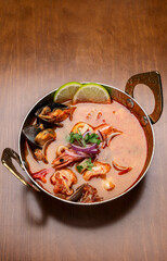 mixed seafood tom yum thai curry soup indoors ina a phuket thailand restaurant