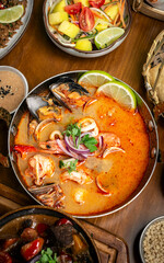 mixed seafood tom yum thai curry soup indoors ina a phuket thailand restaurant