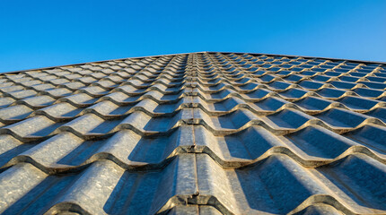 Modern roof tiles pattern under daylight, representing home construction, building material, property protection, architecture design and residential exterior concept.
