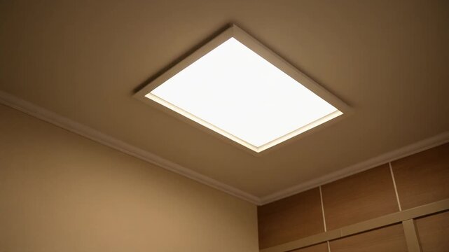 Ceiling light panel turned on in a room.