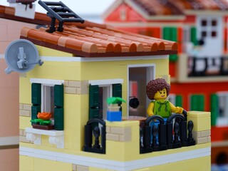 Obraz premium Tambov, Russian Federation - January 05, 2026 A Lego woman minifigure standing on her balcony. LEGO Ideas Italian Riviera set.