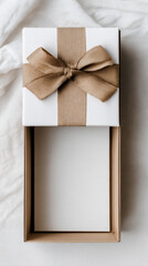 Gift box slightly opened at bottom of vertical frame, airy background.