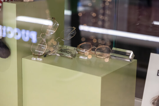 Krakow, Poland - November 30, 2025: Fielmann and Chloe brand eyeglasses displayed in a modern optics store window, showcasing new optical fashion trends for customers