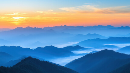 Obraz premium panoramic Asian mountains at sunrise, early year atmosphere, subtle fog between hills, pastel orange and blue sky