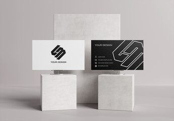
2 Textured Business Cards On White Concrete Display Mockup
