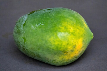 Close-up of a fresh ripe whole papaya fruit on a clean background. A beautiful representation of healthy eating, vitamin-rich tropical fruit, and natural ingredients for a balanced diet.
