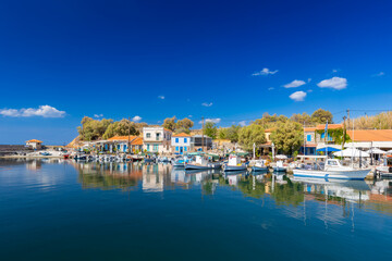 Fototapeta premium The charming Mediterranean port village of Molivos (Mithymna) on the Greek island of Lesvos on a sunny day, wallpaper or background for your project