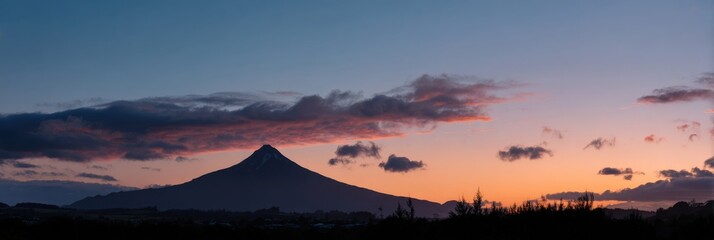 Sunset panorama of mount taranaki with dramatic cloudscape