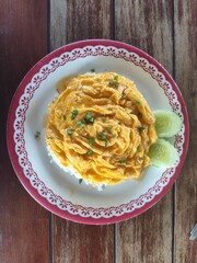 Scrambled eggs served over hot steamed rice, topped with chopped scallions.