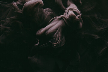 Abstract dark matter, black background. Moving flow of smoke and paints