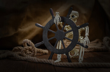 Skeleton at a wooden ship steering wheel in dark pirate setting