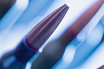 Close-up of rifle cartridges symbolizing the global arms industry, military conflict, and the business of war.