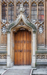 Obraz premium The ornate Gothic entrance to the Divinity School in Oxford. It features intricate stonework and tall stained-glass windows, a historic site known for its use as a Harry Potter filming location.